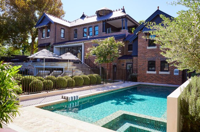 Concrete pool with green tile and Federation home backdrop, landscape architect Sydney